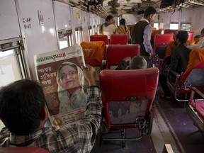 A Bangladeshi reads a newspaper showing a portrait of Prime Minister Sheikh Hasina a day after general elections, at a railway station in Dhaka, Bangladesh, Monday, Dec. 31, 2018. Bangladesh's ruling alliance won virtually every parliamentary seat in the country's general election, according to official results released Monday, giving Hasina a third straight term despite allegations of intimidation and the opposition disputing the outcome.