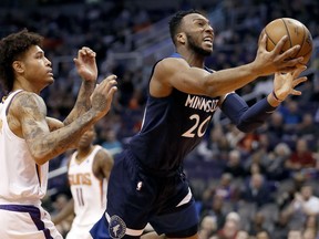 Minnesota Timberwolves guard Josh Okogie (20) drives to the basket as Phoenix Suns forward Kelly Oubre Jr. defends during the first half of an NBA basketball game, Tuesday, Jan. 22, 2019, in Phoenix.