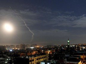 This photo released by the Syrian official news agency SANA, shows missiles flying into the sky near international airport, in Damascus, Syria, Monday, Jan. 21, 2019. In a very unusual move, the Israeli military has issued a statement saying it is attacking Iranian military targets in Syria. It is also warning Syrian authorities not to retaliate against Israel. (SANA via AP)