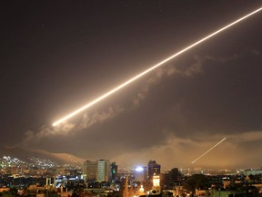 FILE - In this early Saturday, April 14, 2018 file photo, Damascus skies erupt with surface to air missile fire as the U.S. launches an attack on Syria targeting different parts of the Syrian capital Damascus, Syria.   A spokesman for the U.S.-led coalition said Friday, Jan. 11, 2019 that the process of withdrawal in Syria has begun, declining to comment on specific timetables or movements.