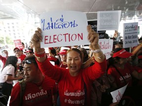 FILE - In this Tuesday, Jan. 8, 2019, file photo, demonstrators hold a rally demanding the general election not be postponed in Bangkok, Thailand. Thailand's royal palace has issued a decree announcing the holding of the first general election since the military took power in 2014. The date of the vote is to be announced by the Election Commission within five days.