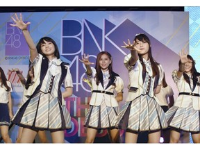 FILE - In this June 2, 2017, file photo, Thai pop band BNK 48 performs for the first time in a large commercial facility in  Bangkok, Thailand. The popular Thai music act BNK 48 has set off a scandal after one of its members wore a shirt showing the swastika flag of Nazi Germany during a performance.