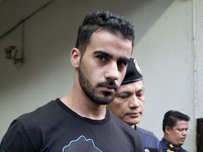 FILE - In this Tuesday, Dec. 11, 2018, file photo, prison guards escort Bahraini football player Hakeem al-Araibi from a court in Bangkok, Thailand. Thailand officially received a request from Bahrain to extradite a detained soccer player who has refugee status in Australia. The foreign ministry says the request for extraditing Hakeem al-Araibi has been forwarded to prosecutors for deliberation.