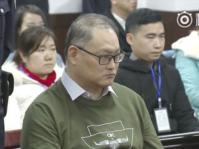 FILE - In this file image taken from a video taken and released on Nov. 28, 2017, by the Intermediate People's Court of Yueyang, Taiwanese human rights activist Lee Ming-che sits during a court session at the Intermediate People's Court of Yueyang in Yueyang in central China's Hunan Province. China says it has banned Lee's wife, Lee Ching-yu from visiting him for three months due to alleged improper behavior.