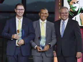 Prime Minister Scott Morrison, right, stands with winners 2019 Australians of the Year; Dr. Richard Harris, left, and Craig Challen at the 2019 Australian of the Year Awards in Canberra, Australia, Friday, Jan. 25, 2019. The two amateur divers Harris and Challen, who canceled their vacation plans for what they thought was a hopeless mission to rescue 12 boys and their soccer coach from a flooded cave in Thailand, have been named winners of one of Australia's most prestigious awards.