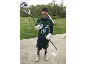 This 2017 photo provided by Mike Song shows his son Ethan Song posing in his lacrosse outfit in their hometown of Guilford, Conn. Ethan Song accidentally shot himself in the head with a handgun owned by his friend's father on Jan. 31, 2018 when he was 15. His death has spurred his parents to advocate for tougher federal and state laws on safe gun storage. Versions of "Ethan's Law" were introduced this month in the U.S. Senate and Connecticut House of Representatives. They would require gun owners to take steps to prevent unauthorized users from accessing their weapons.