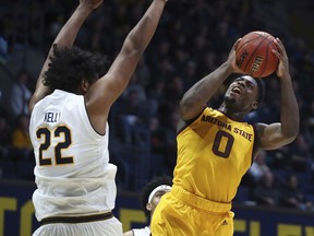 Arizona State guard Luguentz Dort, right, shoots against California's Andre Kelly (22) during the first half of an NCAA college basketball game Wednesday, Jan. 9, 2019, in Berkeley, Calif.