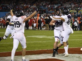 Northwestern offensive lineman Trey Klock (39), center, is congratulated by wide receiver Ramaud Chiaokhiao-Bowman (81) after scoring a touchdown during the second half of the Holiday Bowl NCAA college football game against Utah, Monday, Dec. 31, 2018, in San Diego.