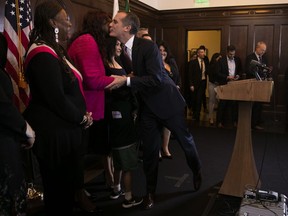 Los Angeles Mayor Eric Garcetti, center, greets with supporters at a news conference Tuesday, Jan. 29, 2019, in Los Angeles. Garcetti will not seek the Democratic presidential nomination in 2020, slightly winnowing a field that is still likely to be large and unwieldy for a party desperate to oust President Donald Trump.