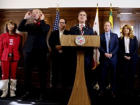 Los Angeles Mayor Eric Garcetti, center at podium, listens to a question during a news conference in Los Angeles after a tentative deal was reached Tuesday, Jan. 22, 2019. Arlene Inouye, from left, team chair with the United Teachers Los Angeles, Justin Maurer, sign language interpreter, Union President Alex Caputo-Pearl, Austin Beutner, Superintendent of the Los Angeles Unified School District, and Vivian Ekchian, deputy superintendent stand in the background. A tentative deal was reached Tuesday between Los Angeles school officials and the teachers union that will allow educators to return to classrooms after a six-day strike against the nation's second-largest district, officials said.