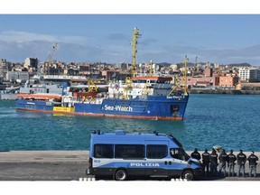 The migrant rescue ship Sea-Watch 3, carrying 47 migrants, comes into dock at the Sicilian port of Catania, southern Italy, Thursday, Jan. 30, 2018. The Sea-Watch 3, operated by the German aid group Sea Watch, was being escorted by Italian coast guard ships into port in Catania on Thursday morning after being kept at sea for nearly two weeks while Italy pressed other European countries to agree to take them in.