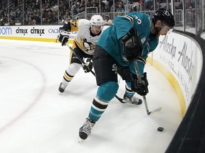 San Jose Sharks right wing Barclay Goodrow (23) battles for the puck against Pittsburgh Penguins center Sidney Crosby (87) during the first period of an NHL hockey game in San Jose, Calif., Tuesday, Jan. 15, 2019.