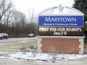 A sign outside the Mundelein Seminary asks the faithful to pray for U.S. based Roman Catholic bishops gathering there for a weeklong prayer retreat, Wednesday, Jan. 2, 2019, in Mundelein, Ill. The bishops are gathering to reflect on the church sexual abuse scandal ahead of a summit of the world's bishops next month at the Vatican aimed at forging a comprehensive response to the crisis.