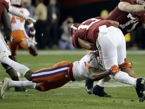 Alabama's Tua Tagovailoa is sacked by Clemson's Trayvon Mullen during the first half of the NCAA college football playoff championship game Monday, Jan. 7, 2019, in Santa Clara, Calif.