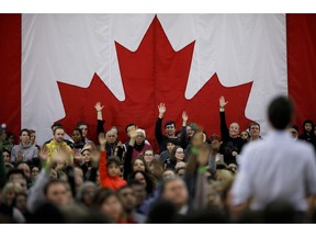 People raise their hands with questions as Canadian Prime Minister Justin Trudeau takes questions at a town hall event in Milton, Ont. on Thursday, Jan. 31, 2019.