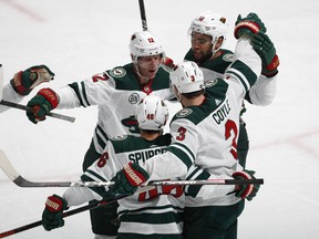 Minnesota Wild center Eric Staal, back left celebrates scoring a goal with left wing Jordan Greenway, back right, center Charlie Coyle, front right, and defenseman Nick Seeler in the first period of an NHL hockey game against the Colorado Avalanche, Wednesday, Jan. 23, 2019, in Denver.