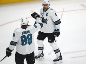 San Jose Sharks defenseman Brent Burns, front, congratulates center Joe Pavelski after he scored a goal against the Colorado Avalanche in the first period of an NHL hockey game Wednesday, Jan. 2, 2019, in Denver.