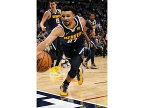 Denver Nuggets guard Jamal Murray dives to try and save the ball from going out of bounds against the Los Angeles Clippers during the first quarter of an NBA basketball game Thursday, Jan. 10, 2019, in Denver.