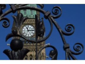 The Peace Tower is seen through the iron gates of Parliament Hill in Ottawa on Thursday, March 19, 2015. Federal politicians will be on election footing as they resume parliamentary business today.