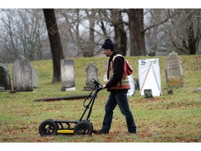 A researcher uses ground-penetrating radar to scan beneath the surface and collect 3D data, which will help map out and identify historic infrastructure and unmarked graves, at the Garrison Graveyard at Fort Anne in Annapolis Royal, N.S. in a Dec., 2018 handout photo.