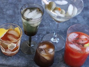 This March 23, 2015 photo shows mixed cocktails, from left, an old fashioned, a vodka gimlet, a Bull Shot, a dry martini and a bloody mary. The federal government is asking Canadians how they like their vodka. The Canadian Food Inspection Agency has opened consultations on whether to redefine the clear, neutral spirit and open interprovincial trade for innovative craft distillers who want to try something new.