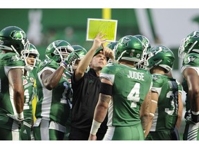Saskatchewan Roughriders special teams co-ordinator Craig Dickenson goes over a play during a break in first half CFL football action against the Hamilton Tiger-Cats in Regina on July 8, 2017. Jeremy O'Day didn't have to look far to find a new head coach for the Saskatchewan Roughriders. The Riders have scheduled a news conference for this afternoon to introduce special teams co-ordinator Craig Dickenson as the new head coach of the team.