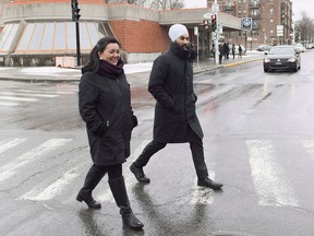 NDP Leader Jagmeet Singh and NDP candidate for the riding of Outremont Julia Sanchez cross a street during a tour of the Montreal borough of Outremont on December 22, 2018. Prime Minister Justin Trudeau has set Feb. 25 as the date for byelections in three vacant ridings -- including the British Columbia riding where NDP Leader Jagmeet Singh is hoping to win a seat in the House of Commons. Trudeau has called the byelections for Burnaby South, the Ontario riding of York-Simcoe and Montreal's Outremont.