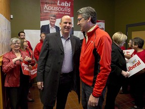 Nova Scotia Liberal Leader Stephen McNeil, right, chats with Labi Kousoulis, in Halifax on Monday, Oct. 7, 2013. Nova Scotia's minimum wage is going up, with the province's labour minister Kousoulis saying the pay hike will help workers and their families.