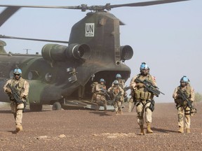 Canadian infantry and medical personnel disembark a Chinook helicopter as they take part in a medical evacuation demonstration on the United Nations base in Gao, Mali, Saturday, December 22, 2018. Canadian peacekeepers in Mali have been pressed into service after extremists with links to Al Qaeda attacked a United Nations base on Sunday, killing 10 and injuring dozens more.