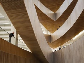 Visitors explore the new Calgary Library following its opening in Calgary, Alta., on November 1, 2018. The Alberta government is spending $1 million on a program at Calgary's new central library to preserve Indigenous languages. Premier Rachel Notley says she can't think of a better place to house the Indigenous Languages Resource Centre. Calgary's new $245-million, 22,000-square-metre library opened last November to much fanfare and has drawn praise for its airy, modernist design.