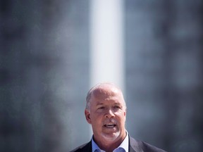 B.C. Premier John Horgan speaks during an announcement in Surrey, B.C., on September 4, 2018. Premier John Horgan is putting pressure on the Opposition Liberals to explain allegations made by the Speaker of "flagrant overspending" by two top legislature officials dating back to when the party was in power.THE CANADIAN PRESS/Darryl Dyck