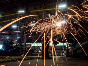 A man uses a grinder on a steel stairs being manufactured for a high school in Redmond, Wash., at George Third & Son Steel Fabricators and Erectors, in Burnaby, B.C., on Thursday March 29, 2018. American automakers, aluminum producers, manufacturers and farmers are running out of time, money and patience as the North American tariff standoff persists, and they're pleading with the United States to put an end to it.