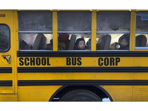 Another day begins on the yellow bus, as children peer through fogged-over windows on their way to school in Brooklyn, New York on Wednesday, Dec. 5, 2018. Transport Minister Marc Garneau announced a task force look at the possibility of retrofitting school buses with seat belts.