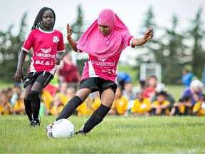 Children in the Free Footie program play soccer during an outdoor tournament in a handout photo.