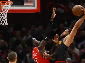 Atlanta Hawks guard Justin Anderson (1) goes up for a dunk as Chicago Bulls forward Bobby Portis (5) defends during the first half of an NBA basketball game Wednesday Jan. 23, 2019, in Chicago.