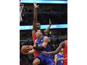 Orlando Magic forward Aaron Gordon, front, goes to the basket as Chicago Bulls forward Wendell Carter Jr. (34) defends him during the first half of an NBA basketball game Wednesday, Jan. 2, 2019 in Chicago.