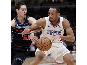 Los Angeles Clippers guard Avery Bradley, right, drives against Chicago Bulls guard Ryan Arcidiacono during the first half of an NBA basketball game Friday, Jan. 25, 2019, in Chicago.