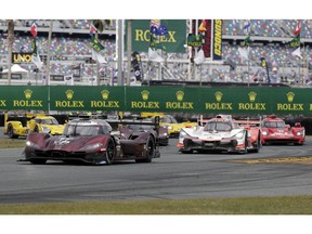 Pole sitter Oliver Jarvis, of Great Britain, front left, leads the start of the IMSA 24 hour auto race out of a horseshoe turn at Daytona International Speedway, Saturday, Jan. 26, 2019, in Daytona Beach, Fla.