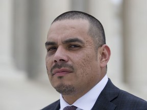 Clayvin Herrera poses for a picture on the plaza of the Supreme Court, Tuesday, Jan. 8, 2019, in Washington. The U.S. Supreme is reviewing a case in which Clayvin Herrera, a Crow tribal member and former tribal game warden from Montana, is asserting his right under a 150-year-old treaty with the U.S. government to hunt elk in the Bighorn National Forest in Wyoming.
