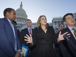 Rep. Joe Neguse, D-Colo., left, Rep. Sean Casten, D-Ill., Rep. Katie Hill, D-Calif., Rep. TJ Cox, D-Calif., and other freshmen members of the House of Representatives speak about the government shutdown in front of the U.S. Senate on Capitol Hill, Tuesday, Jan. 15, 2019 in Washington.
