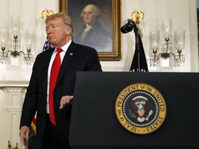 President Donald Trump leaves the podium after speaking about the partial government shutdown, immigration and border security in the Diplomatic Reception Room of the White House, in Washington, Saturday, Jan. 19, 2019.