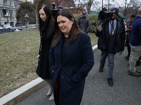 White House press secretary Sarah Huckabee Sanders walks off after speaking with reporters outside the White House, Wednesday, Jan. 23, 2019, in Washington.