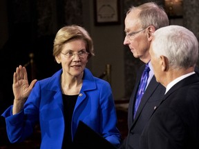 Vice President Mike Pence administers a ceremonial Senate oath during a mock swearing-in ceremony to Sen. Elizabeth Warren, D-Mass., accompanied by her husband Bruce Mann, Thursday, Jan. 3, 2019, in the Old Senate Chamber on Capitol Hill in Washington.