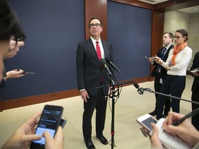 Treasury Secretary Steven Mnuchin speaks to reporters after giving a classified briefing to members of the House of Representatives, telling them that the Trump administration will keep strict U.S. sanctions on the Russian oligarch Oleg Deripaska, on Capitol Hill in Washington, Thursday, Jan. 10, 2019.