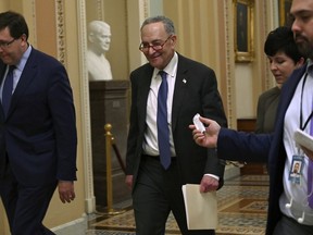 Senate Minority Leader Sen. Chuck Schumer of N.Y., center, talks with reporters as he walks on Capitol Hill in Washington, Wednesday, Jan. 2, 2019, after returning from a meeting with President Donald Trump at the White House.