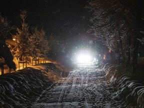A car drives on a snow covered street at the Bavarian city Berchtesgaden, Germany, Friday, Jan 11, 2018, after Austria and southern Germany were hit by heavy snowfall.