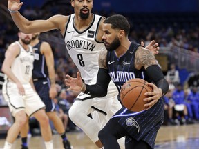 Orlando Magic's D.J. Augustin, right, makes a move to get past Brooklyn Nets' Spencer Dinwiddie (8) during the first half of an NBA basketball game Friday, Jan. 18, 2019, in Orlando, Fla.