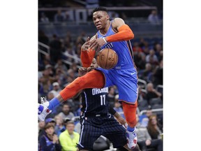 Oklahoma City Thunder's Russell Westbrook, right, loses control of the ball going up for a shot after he was fouled by Orlando Magic's Jonathon Simmons (17) during the first half of an NBA basketball game, Tuesday, Jan. 29, 2019, in Orlando, Fla.