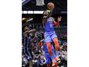 Oklahoma City Thunder's Paul George (13) goes past Orlando Magic's Jonathan Isaac, left, for a basket during the first half of an NBA basketball game, Tuesday, Jan. 29, 2019, in Orlando, Fla.