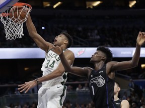 Milwaukee Bucks' Giannis Antetokounmpo (34) goes to the basket in front of Orlando Magic's Jonathan Isaac (1) during the second half of an NBA basketball game Saturday, Jan. 19, 2019, in Orlando, Fla.